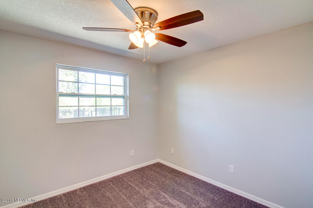 1634 Derringer Road Jacksonville, FL 32225 - Photo 29 of 41 an empty room with a window and a fan