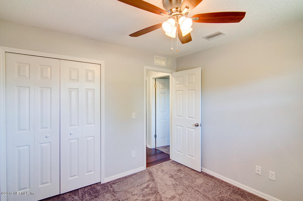 1634 Derringer Road Jacksonville, FL 32225 - Photo 30 of 41 an empty room with closet and a chandelier fan