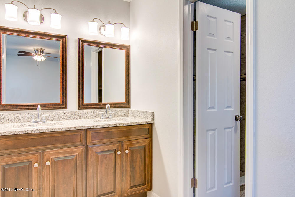 1634 Derringer Road Jacksonville, FL 32225 - Photo 34 of 41 a bathroom with a granite countertop sink and a mirror
