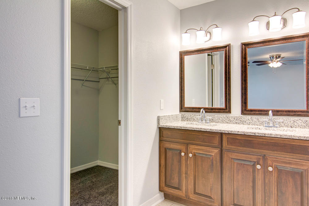 1634 Derringer Road Jacksonville, FL 32225 - Photo 35 of 41 a bathroom with a granite countertop sink and a mirror
