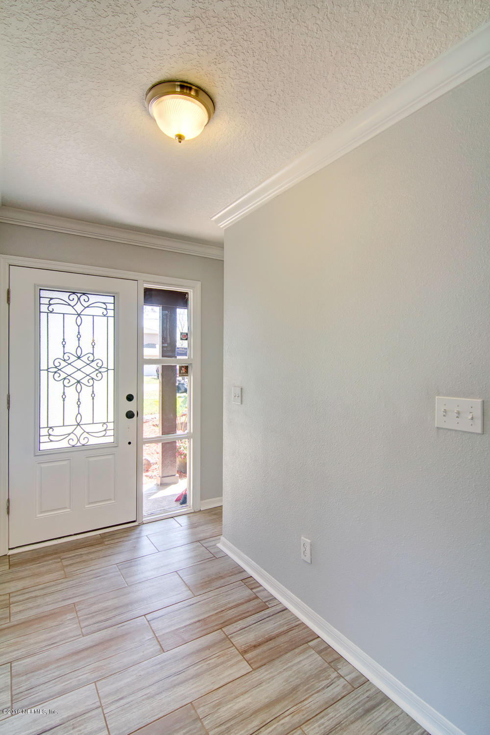 1634 Derringer Road Jacksonville, FL 32225 - Photo 4 of 41 an empty room with wooden floor and windows