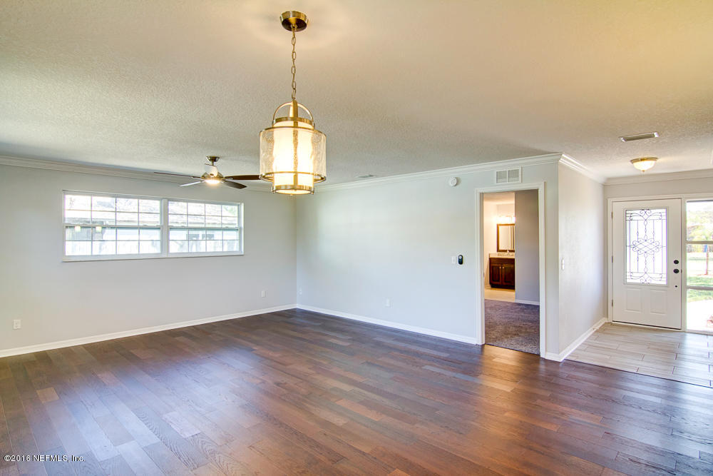 1634 Derringer Road Jacksonville, FL 32225 - Photo 5 of 41 a view of an empty room with wooden floor and a window