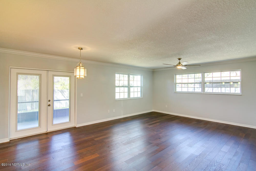 1634 Derringer Road Jacksonville, FL 32225 - Photo 6 of 41 an empty room with wooden floor and windows