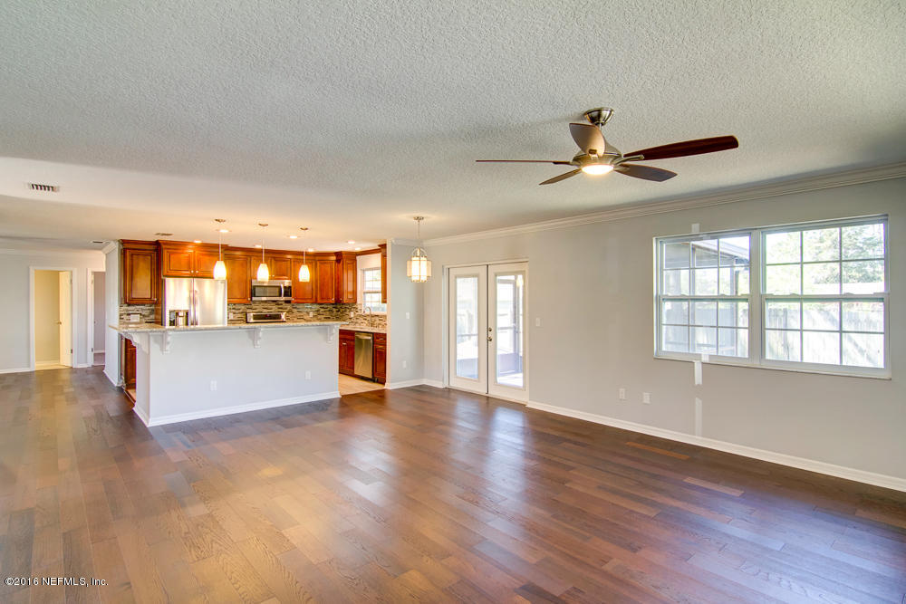 1634 Derringer Road Jacksonville, FL 32225 - Photo 7 of 41 a view of an empty room with window and wooden floor