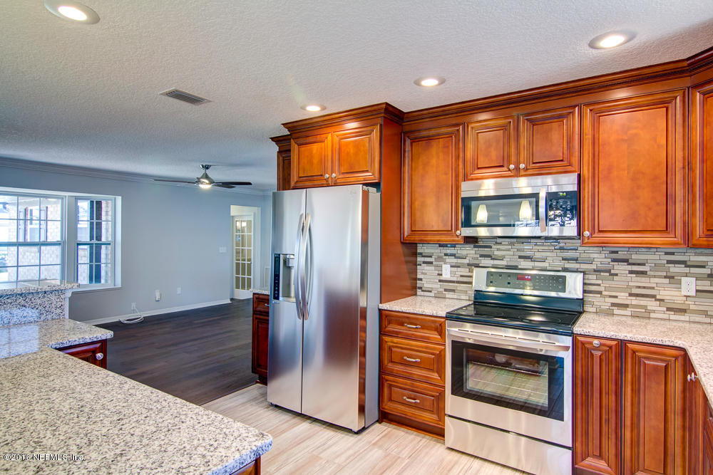 1634 Derringer Road Jacksonville, FL 32225 - Photo 10 of 41 a kitchen with stainless steel appliances granite countertop a refrigerator stove and sink