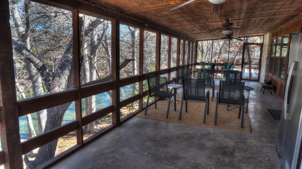 187 Roy Chisum Road Leakey, TX 78873 - Photo 7 of 40 a view of a porch with chairs and furniture