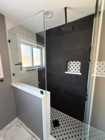 a bathroom with a shower and a sink