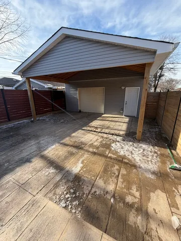 a backyard of a house with table and chairs