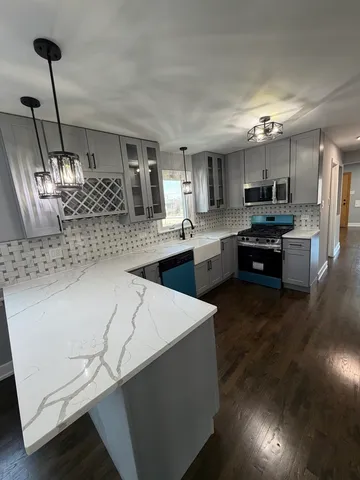 a kitchen with stainless steel appliances kitchen island granite countertop a sink dishwasher stove and oven