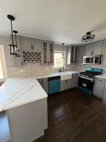a kitchen with stainless steel appliances a sink stove and cabinets