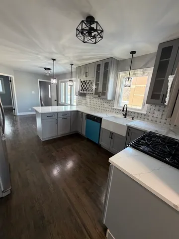 a kitchen that has a sink and a stove