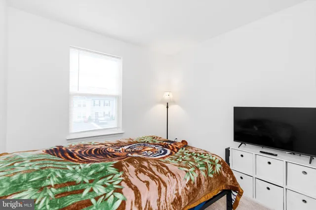 a bedroom with a bed and a mirror