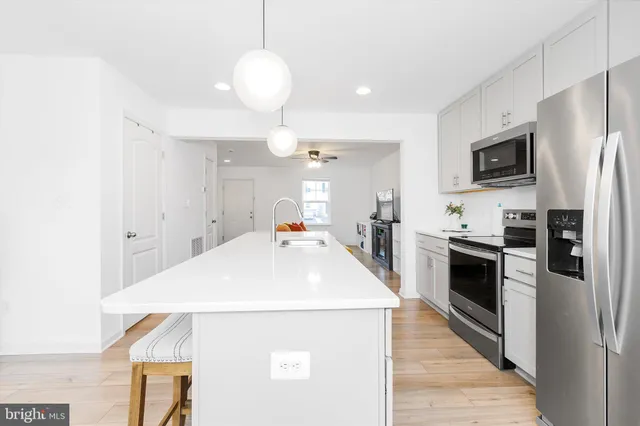 a kitchen with stainless steel appliances granite countertop a sink and a window