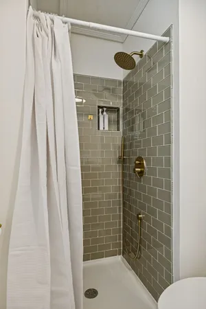 a bathroom with a shower and a toilet