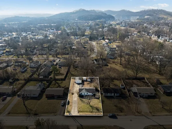 an aerial view of residential houses with city view
