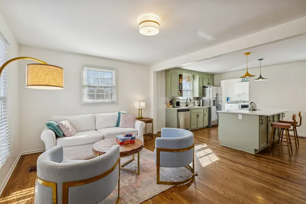 a living room with furniture a window and kitchen view