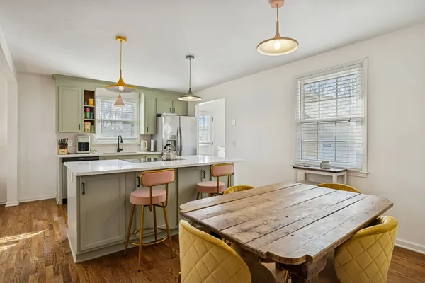 a dining table with chairs and window