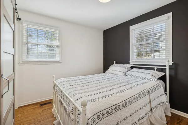 a bed sitting in a bedroom next to a window