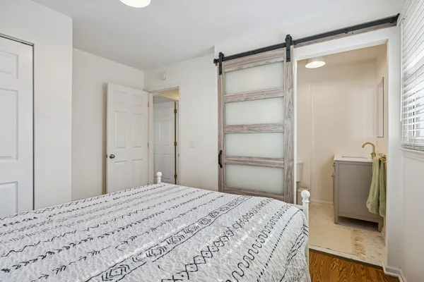 a bedroom with a bed and a bathroom