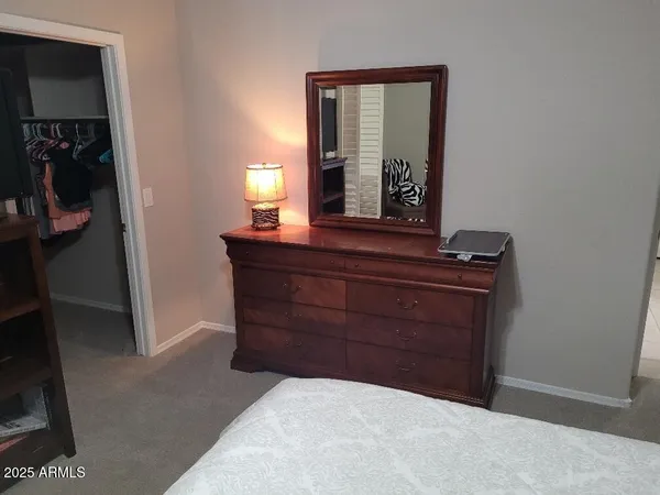 a room with a mirror and a dresser