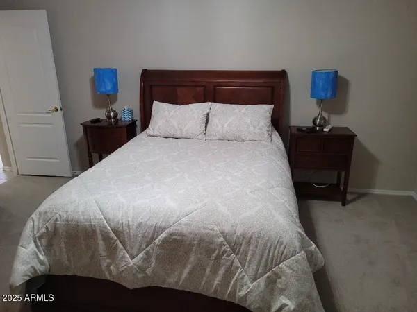 a bedroom with a bed and a night stand