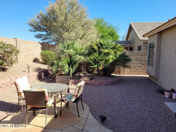 a view of a patio with table and chairs and potted plants