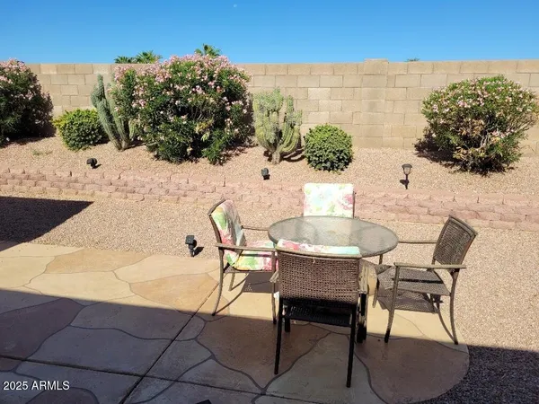 a view of a chairs and table in the ocean