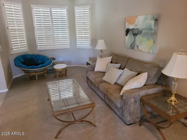 a living room with furniture a window and a table