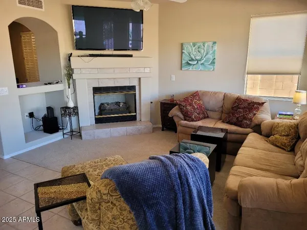 a living room with furniture and a fireplace