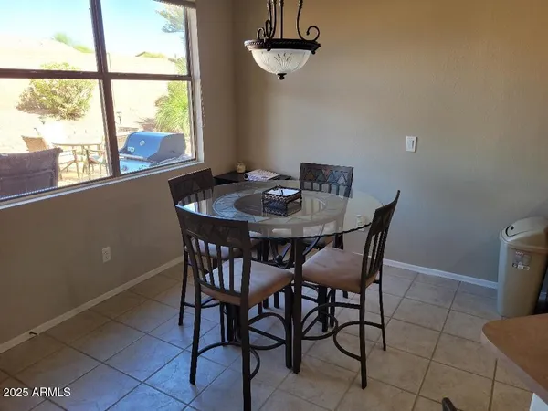 a view of a dining room with furniture and window