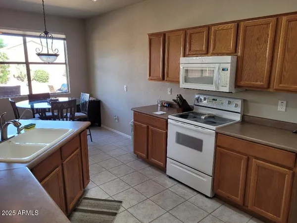 a kitchen with a stove sink and cabinets