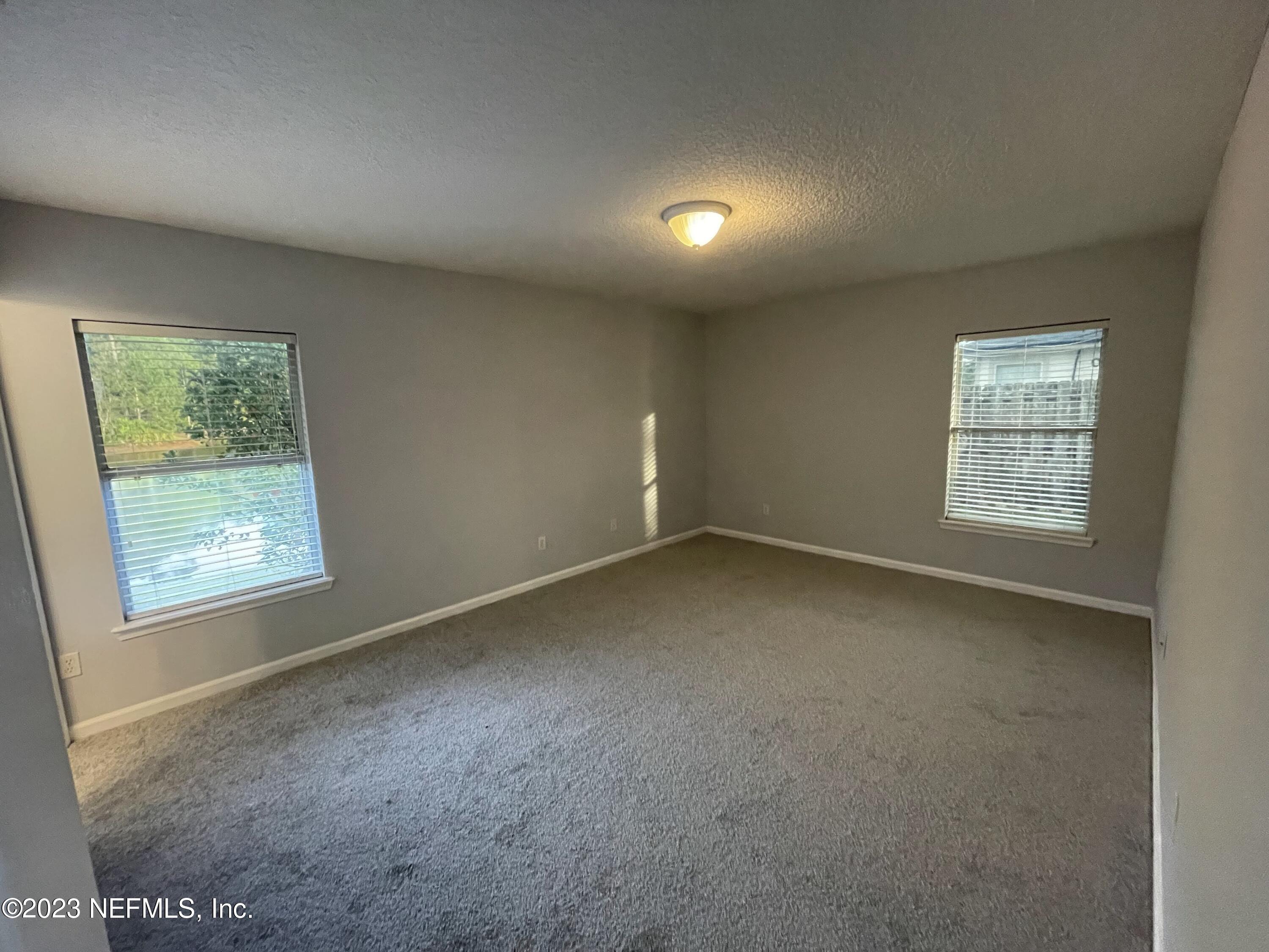 86050 Sands Way Yulee, FL 32097 - Photo 11 of 15 an empty room with windows