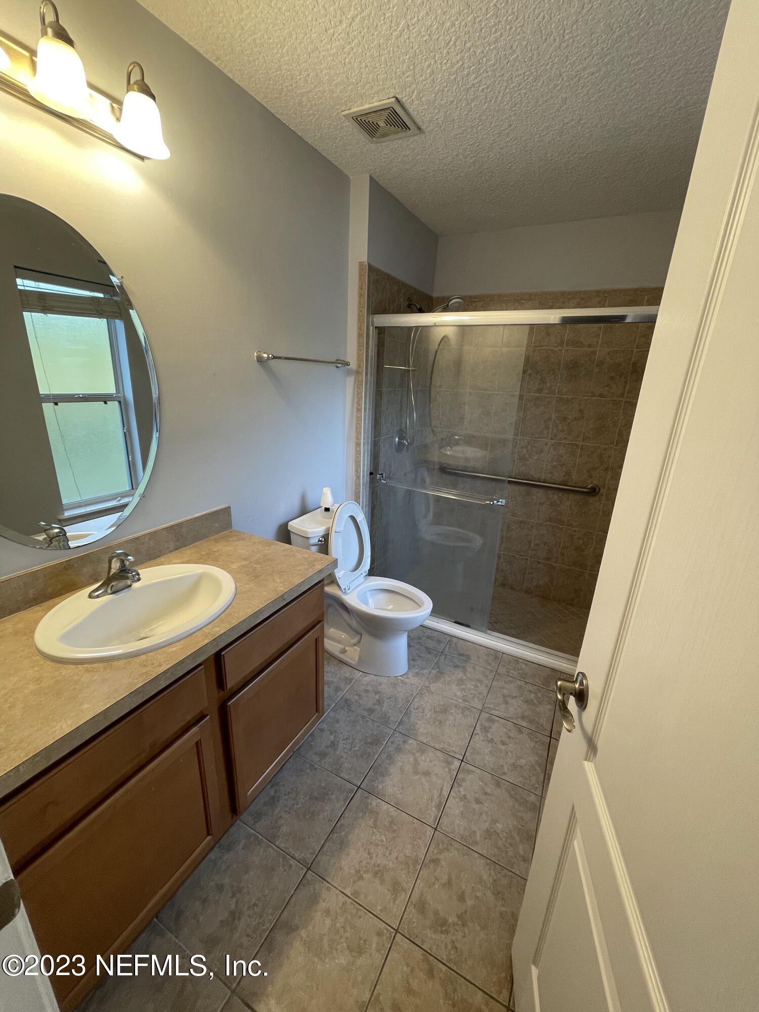 86050 Sands Way Yulee, FL 32097 - Photo 12 of 15 a bathroom with a sink toilet and shower