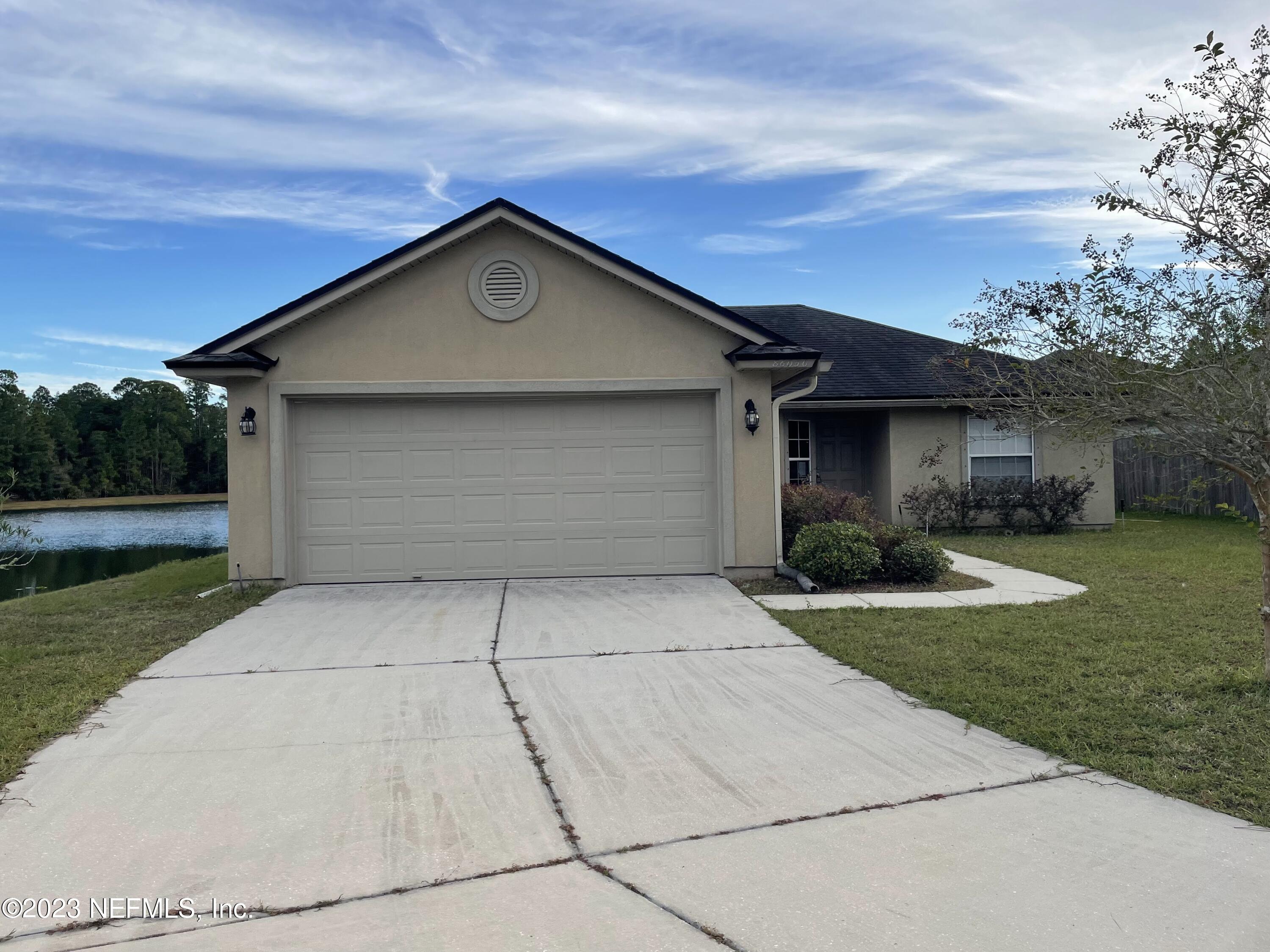 86050 Sands Way Yulee, FL 32097 - Photo 4 of 15 a front view of house with yard and green space