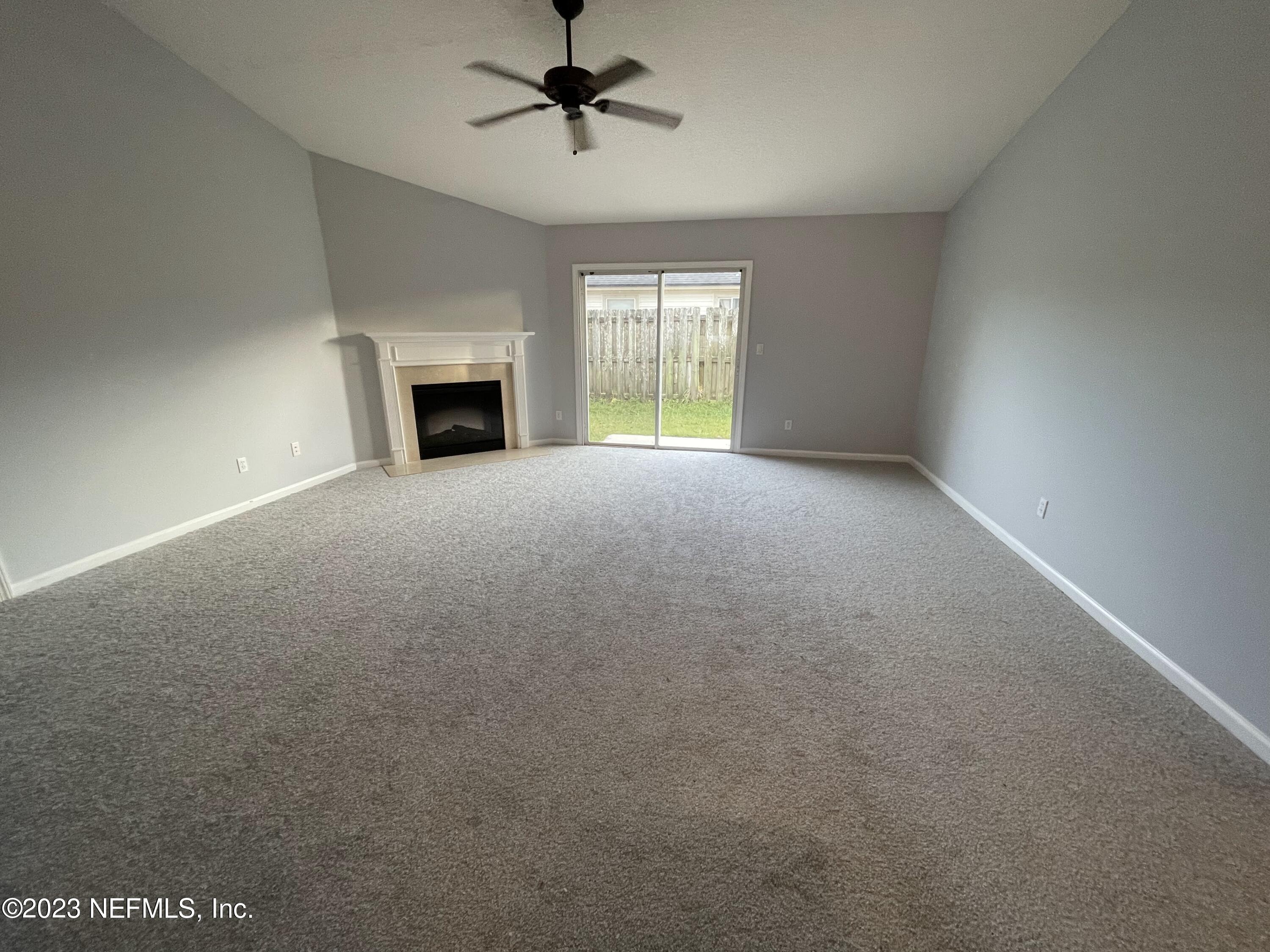 86050 Sands Way Yulee, FL 32097 - Photo 7 of 15 a view of empty room with window and fireplace