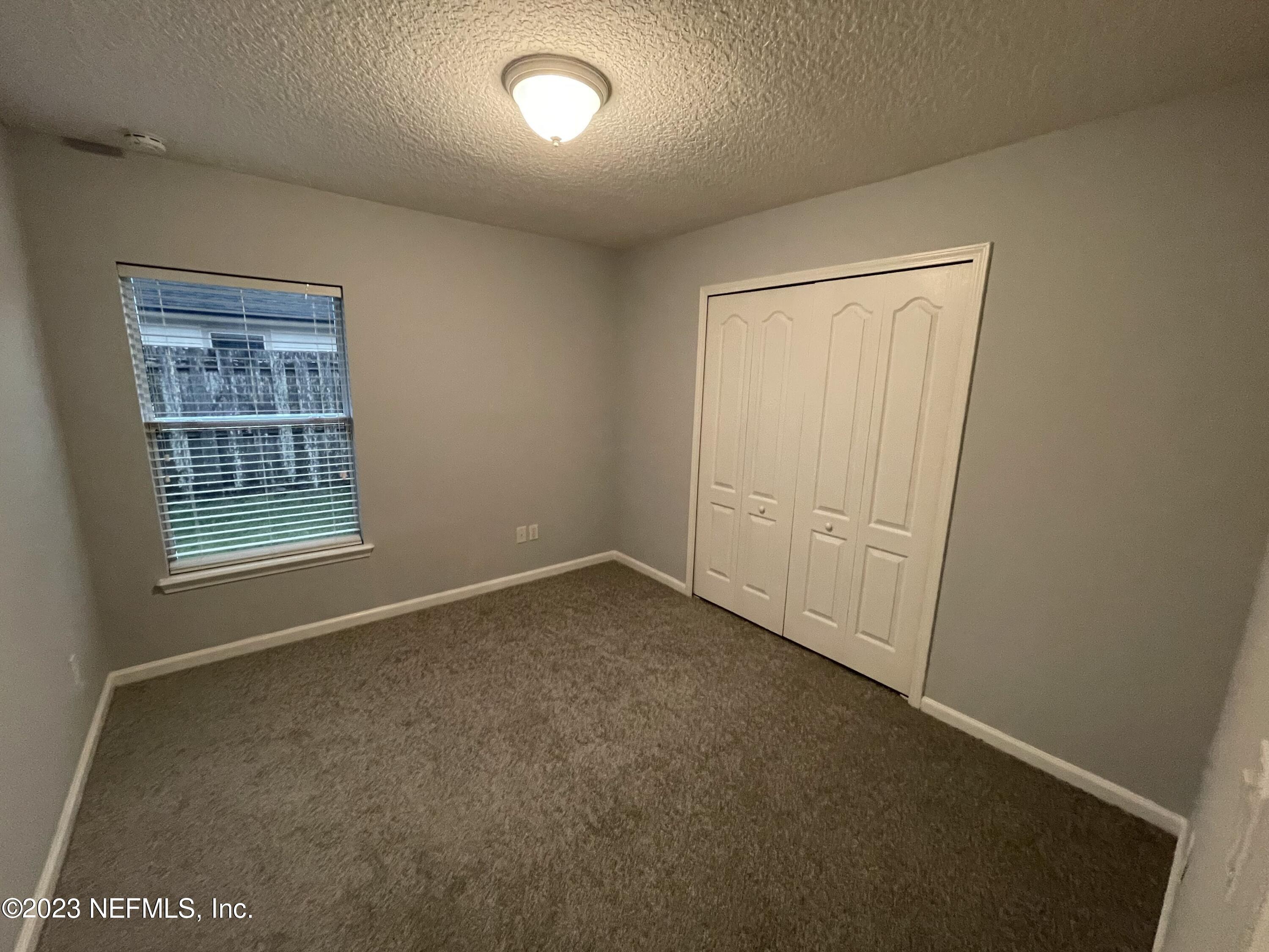 86050 Sands Way Yulee, FL 32097 - Photo 8 of 15 an empty room with windows