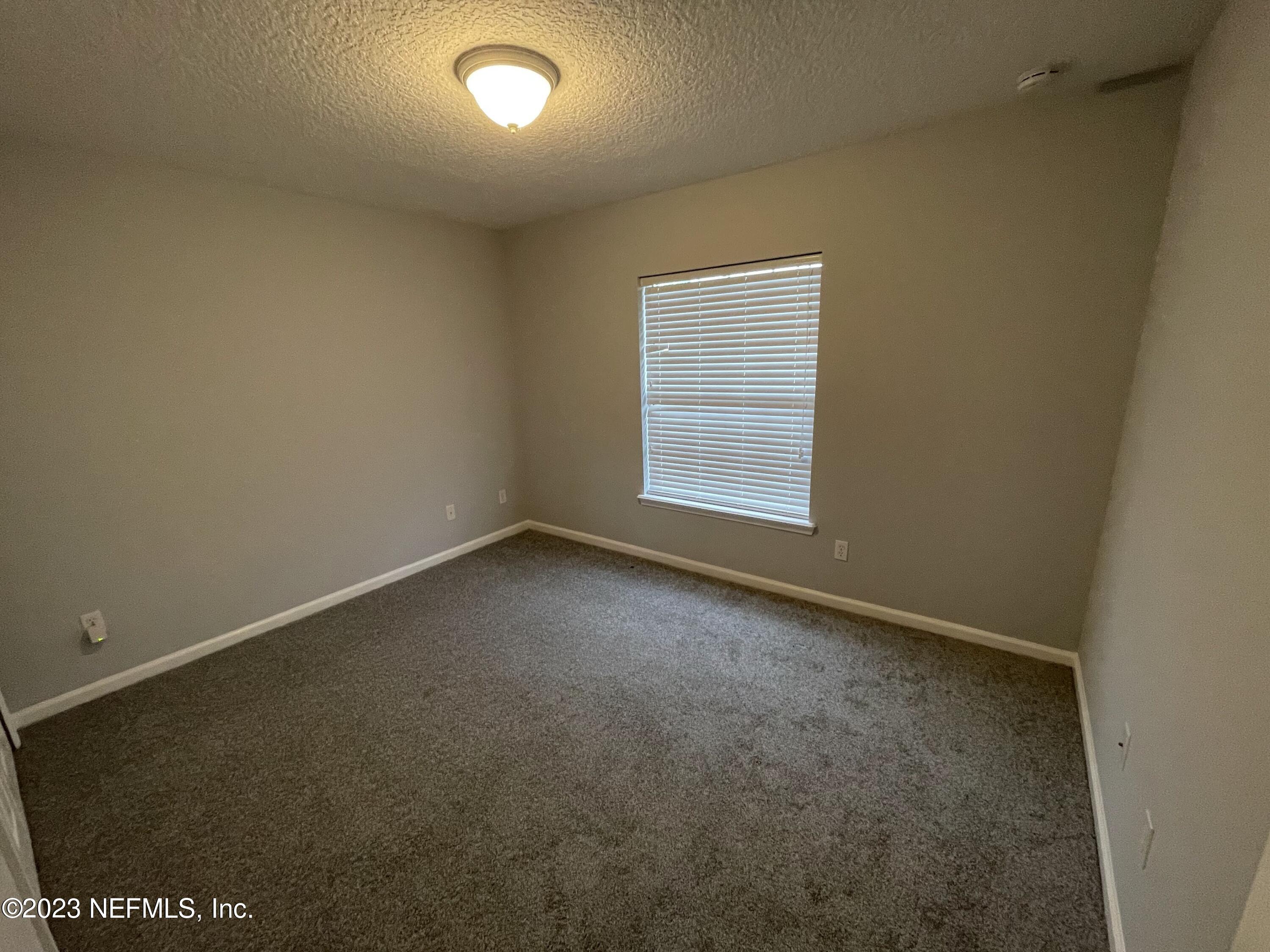 86050 Sands Way Yulee, FL 32097 - Photo 9 of 15 an empty room with a window