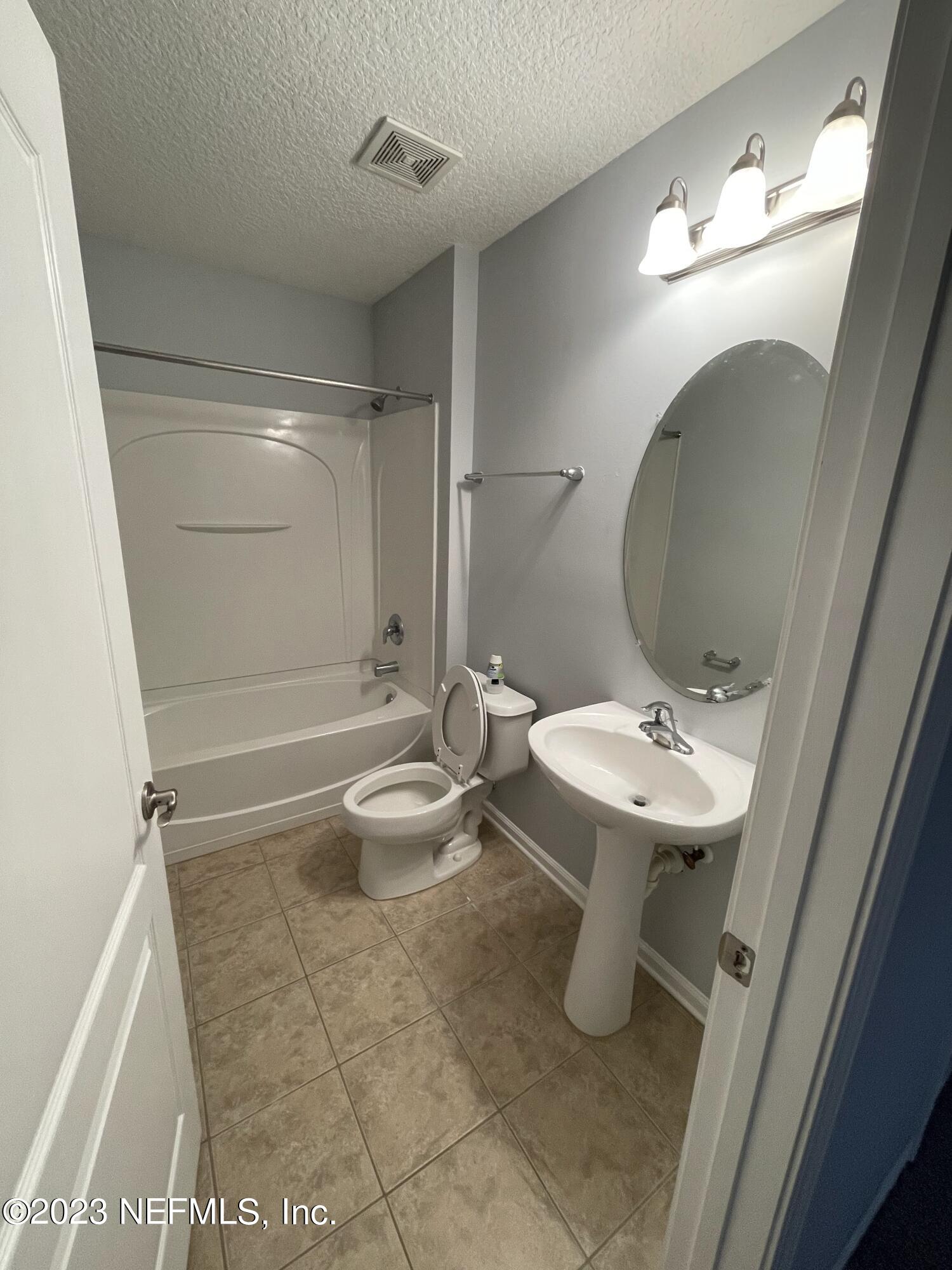86050 Sands Way Yulee, FL 32097 - Photo 10 of 15 a bathroom with a sink a toilet and shower