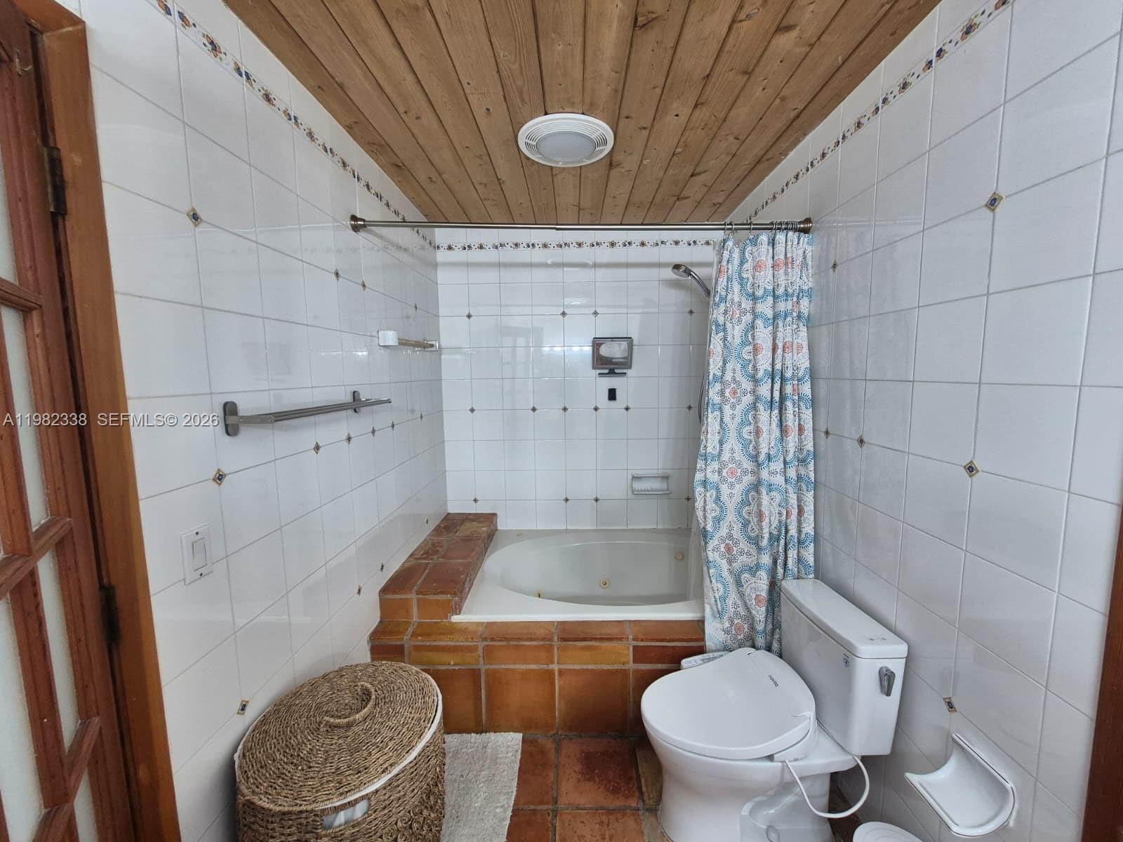 14530 Southwest 110th Street Miami, FL 33186 - Photo 22 of 45 a bathroom with a granite countertop toilet and a shower