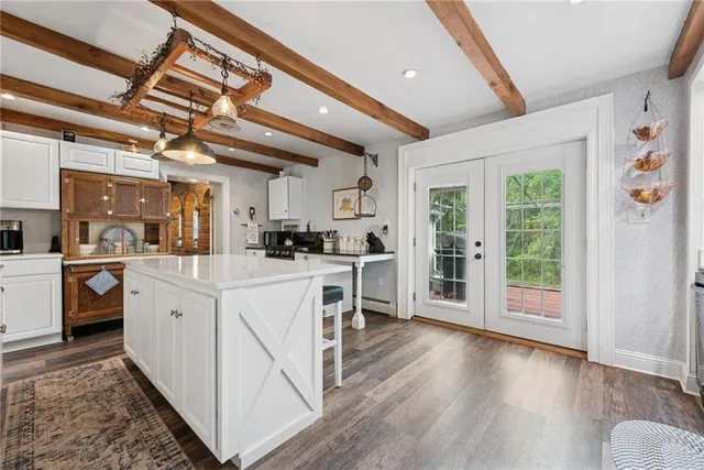 a kitchen with white cabinets and white appliances