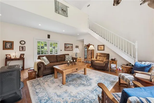 a living room with furniture and a wooden floor