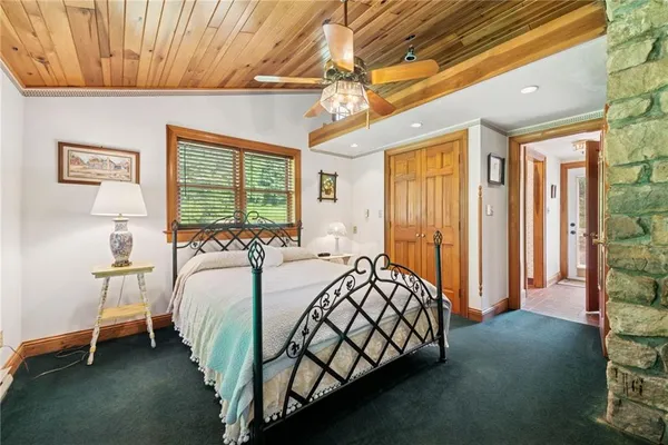 a bed sitting in a bedroom next to a window