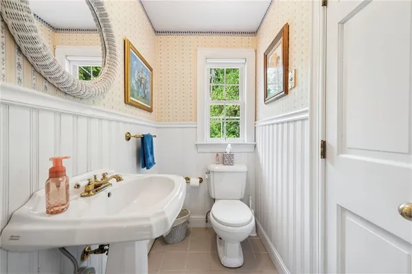 a bathroom with a sink toilet and a mirror