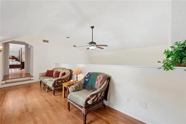 a living room with furniture and a wooden floor
