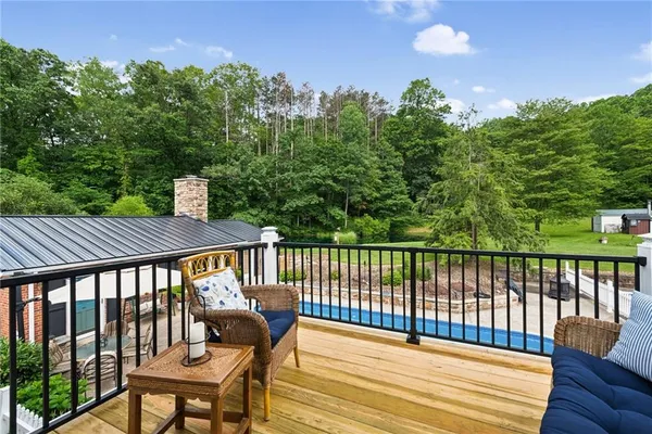 a view of a balcony with wooden floor and outdoor space