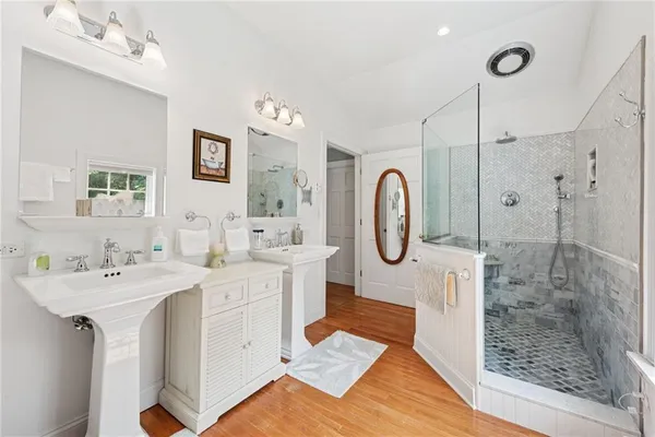 a spacious bathroom with a double vanity sink mirror and shower