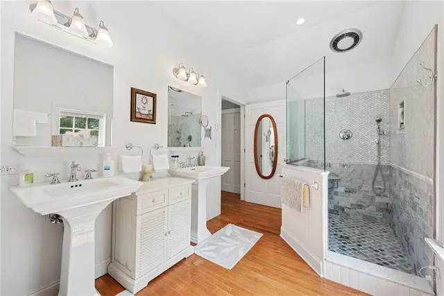 a spacious bathroom with a double vanity sink mirror and shower
