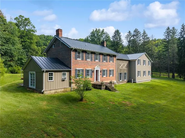 a front view of a house with a garden