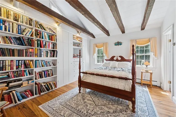 a living room with a book shelf and a rug