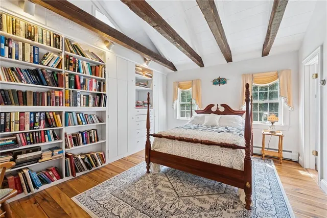 a living room with a book shelf and a rug
